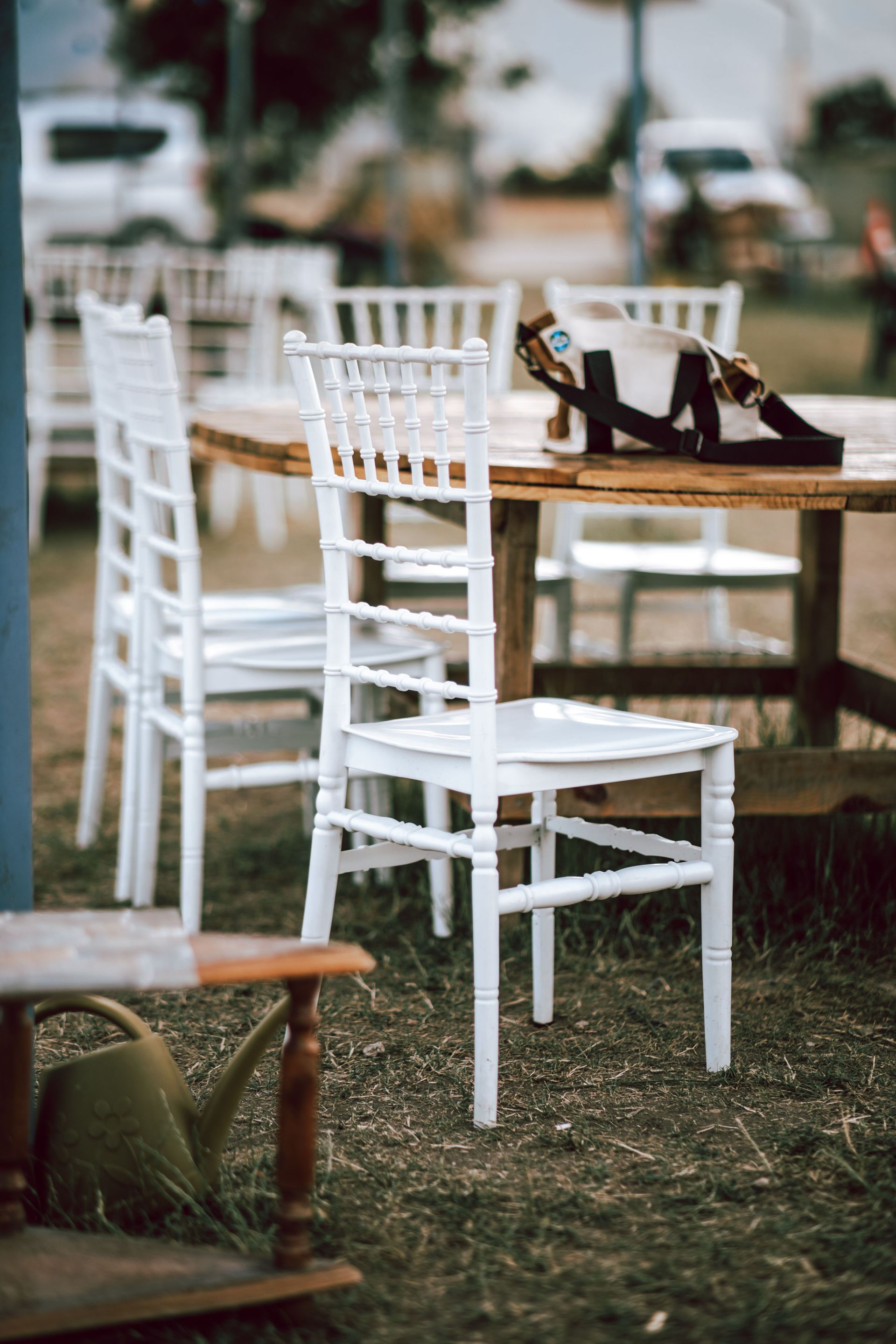 White chairs and wooden table create a cozy outdoor setting.