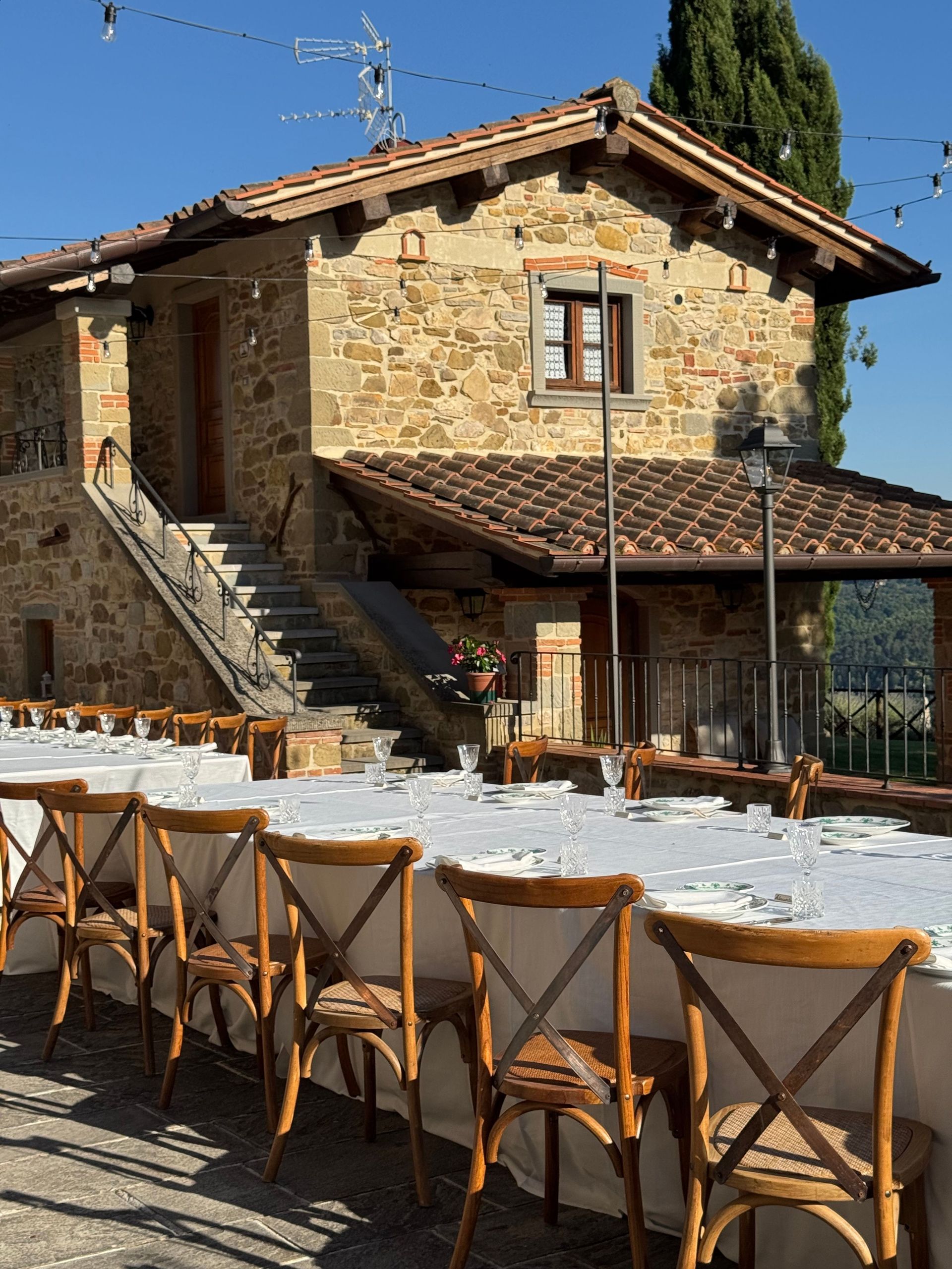 Beautiful Tuscan villa setup for outdoor dining, perfect for gatherings.